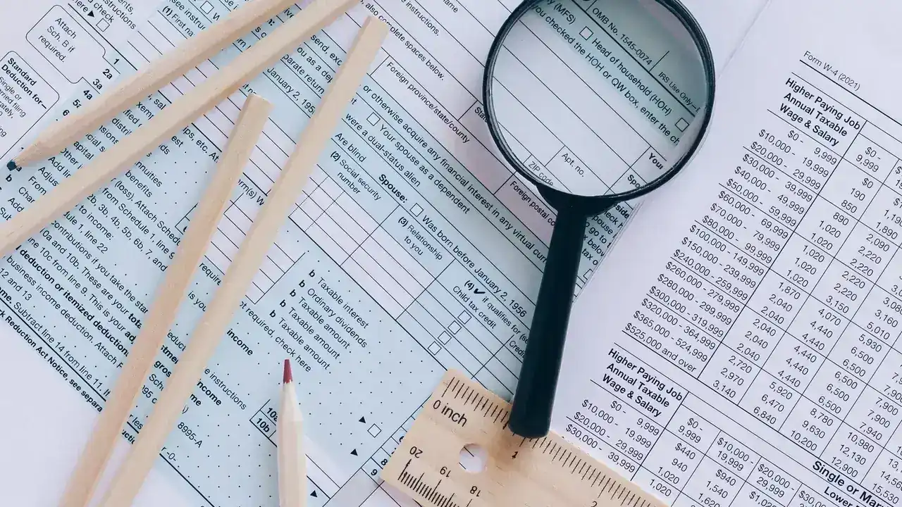 Tax documents, calculator, and financial records arranged for review