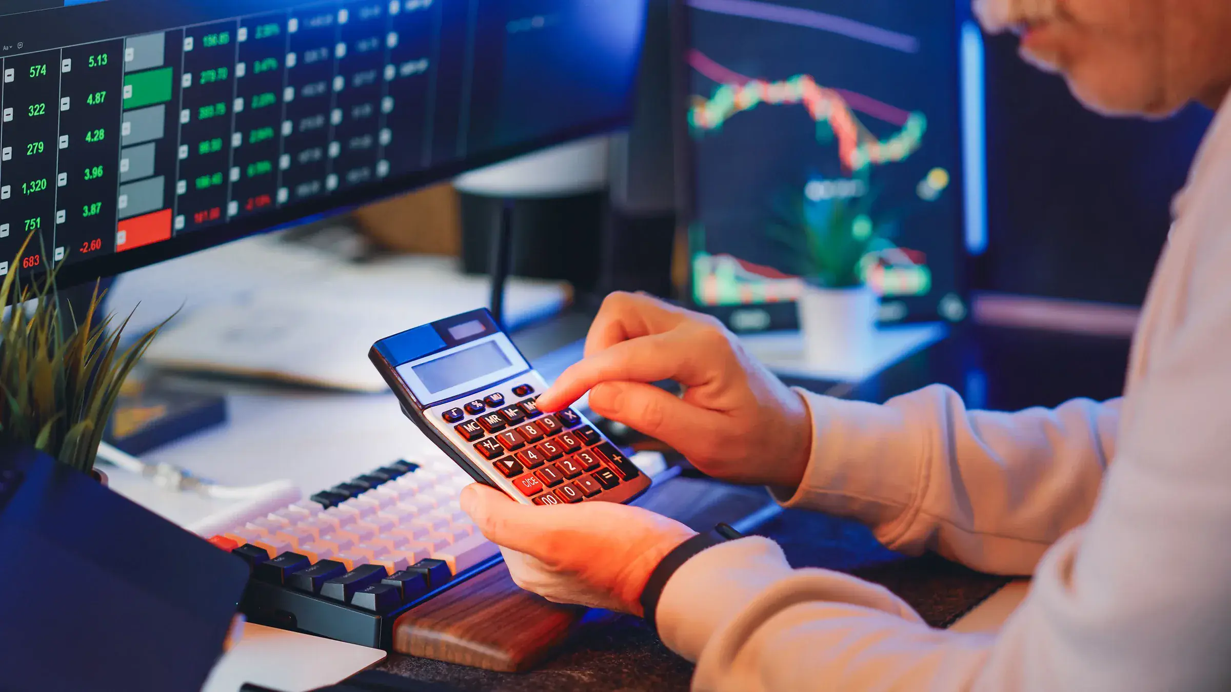 Investor reviewing multiple market screens while mapping portfolio risks